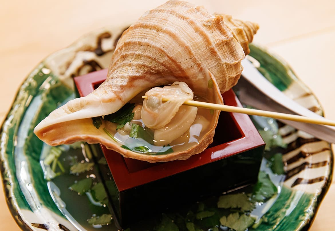 「貝つぼ焼き」590円は貝の出汁が効いたスープも味わいたい