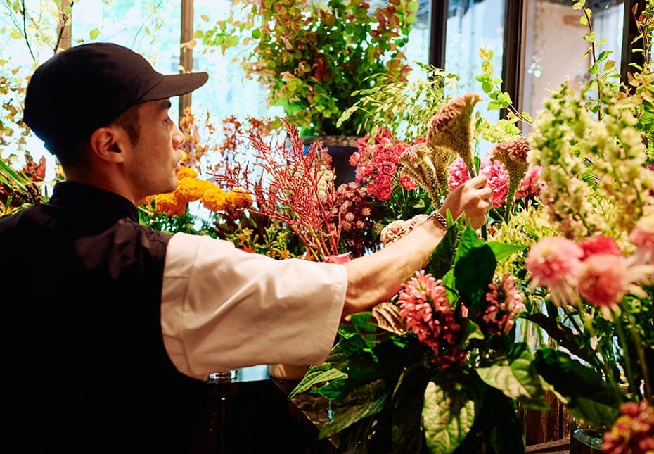 ガラス張りのお部屋から花を選ぶ店長の廣田さん
